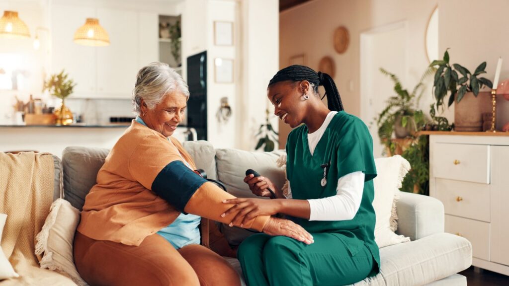 A nurse taking a blood pressure reading of a female patient.