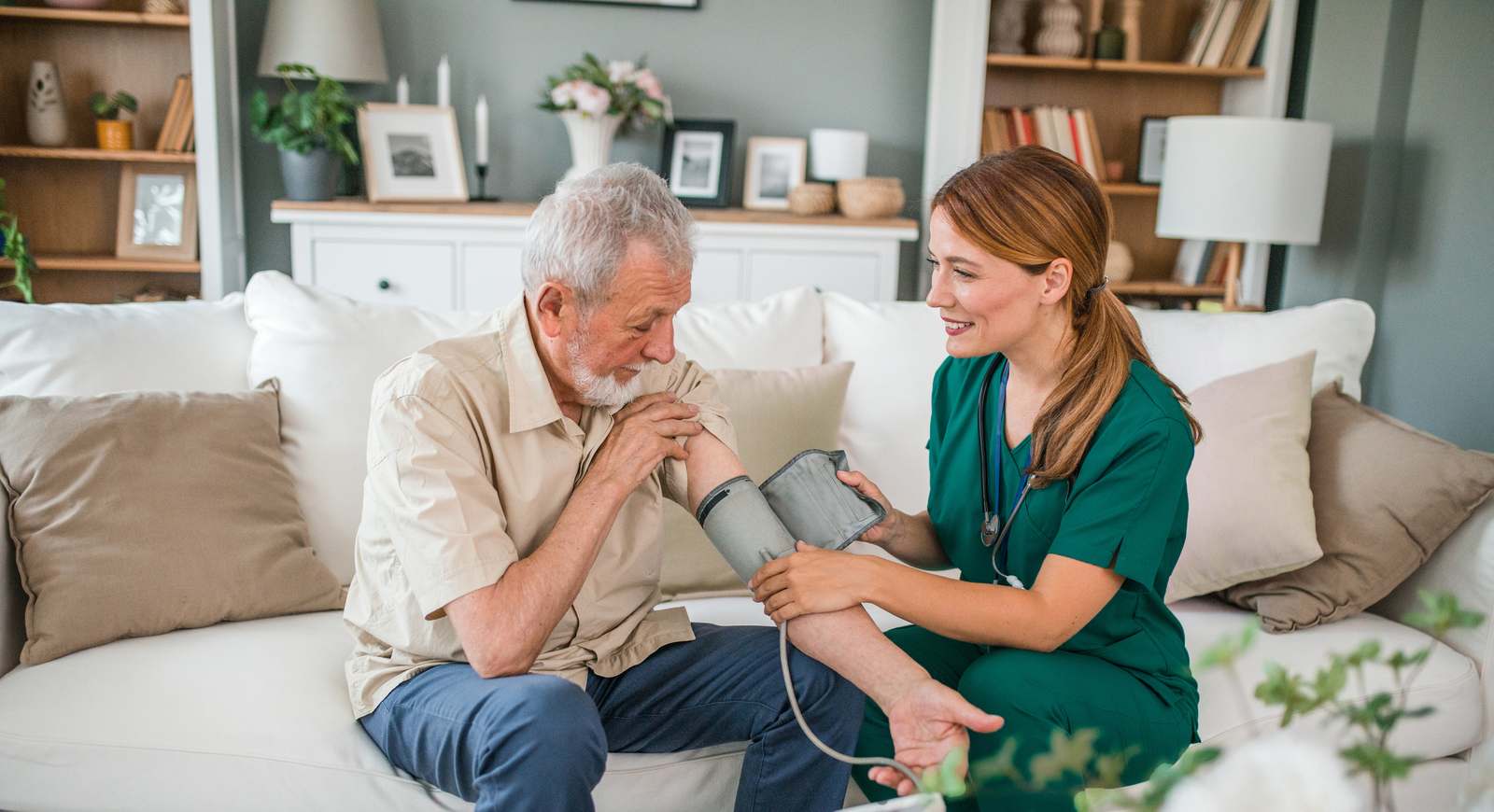 Amerita nurse checking an older patient blood pressure at home